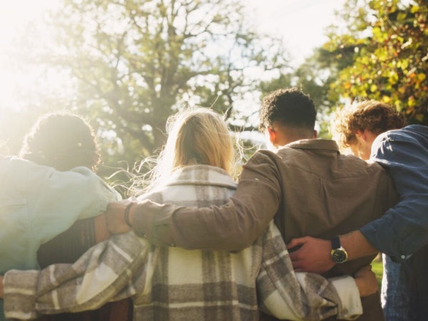 a group links arms around each other's shoulders