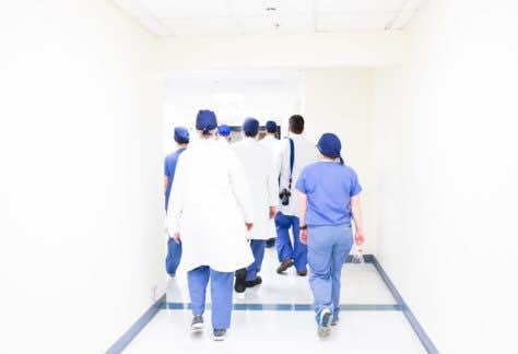 photo of doctors and nurses walking down a hospital hallway